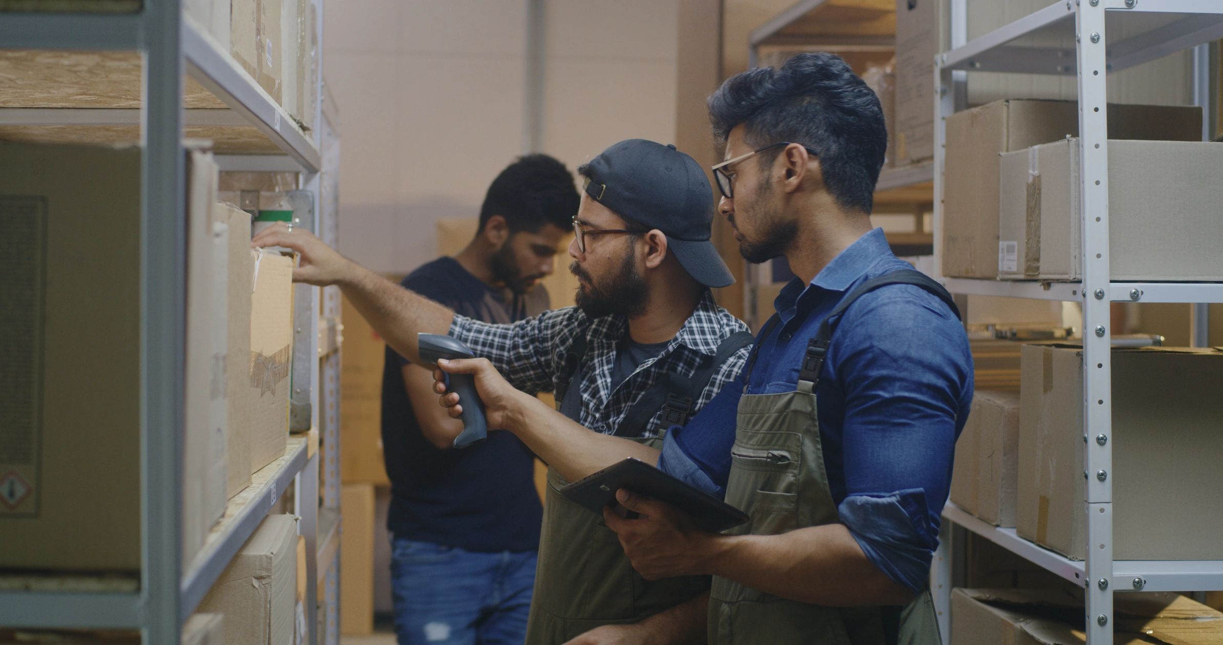 Workers checking boxes in a distribution center