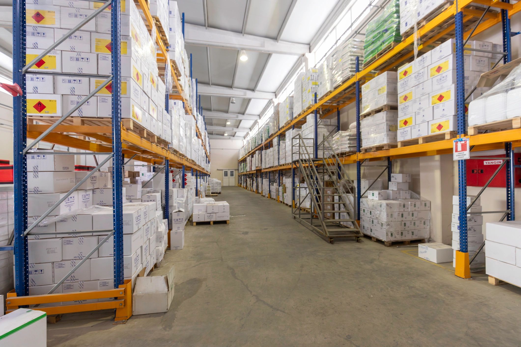 Organized warehouse aisle with stacked cartons for bulk produce inventory