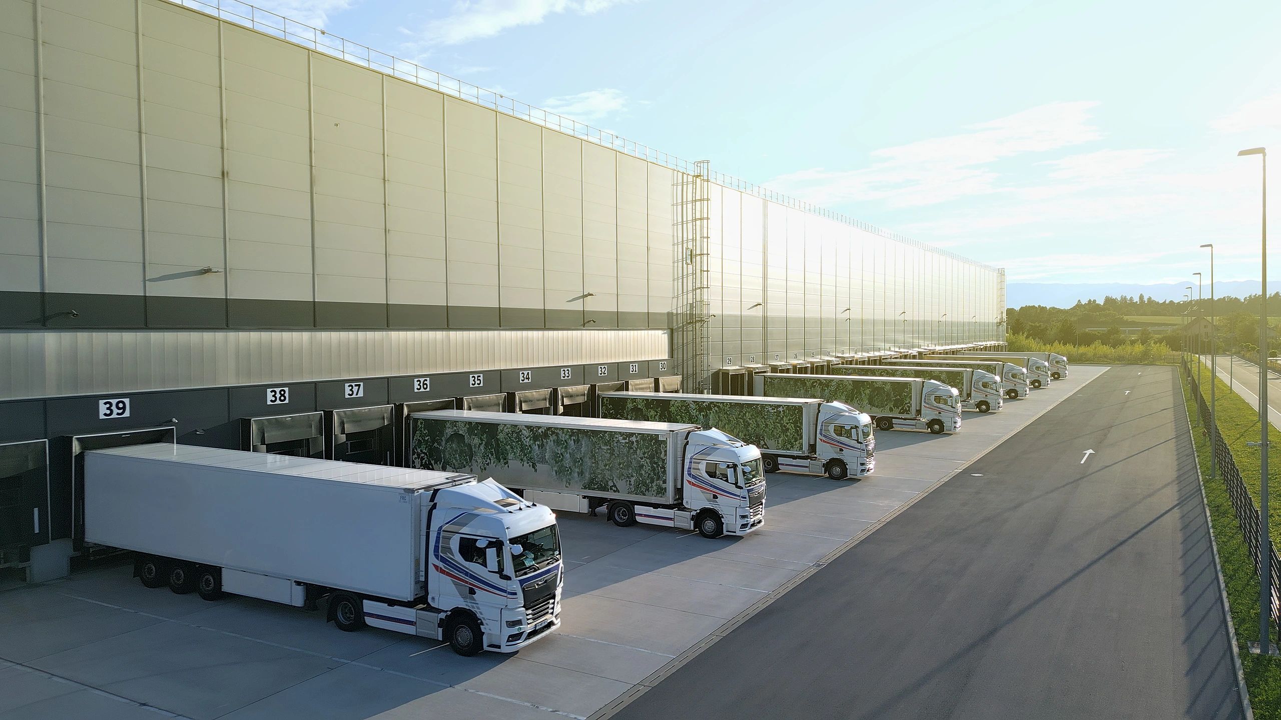Refrigerated logistics fleet at a distribution hub for bulk produce delivery